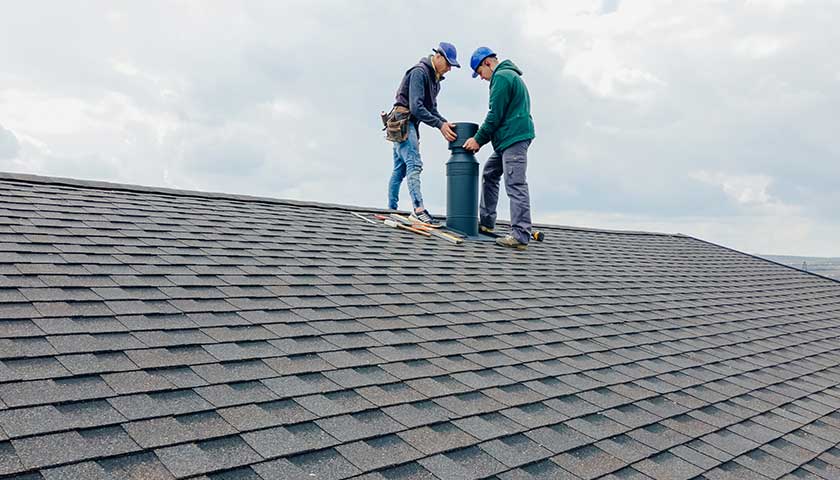 Construction workers Installing chimney and building