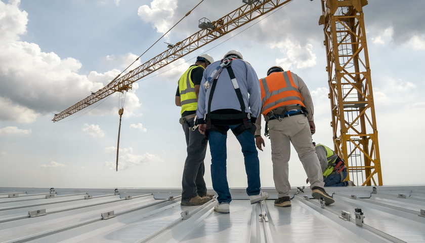 Construction engineer wear safety uniform inspection metal roofi